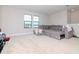 Large bonus room with gray sectional sofa and carpet flooring at 12795 Fisherville Way, Riverview, FL 33579