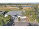 Aerial view of single-story home with two-car garage, situated on a golf course at 1312 Leland Dr # 61, Sun City Center, FL 33573