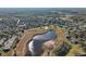 Aerial view of homes and a tranquil pond in a residential community at 1312 Leland Dr # 61, Sun City Center, FL 33573