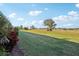 View of backyard with grassy area and mature trees at 1312 Leland Dr # 61, Sun City Center, FL 33573