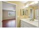 Bathroom with double vanity and view of bedroom at 1312 Leland Dr # 61, Sun City Center, FL 33573