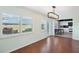 Dining room with hardwood floors, a view into the kitchen, and access to the patio at 1312 Leland Dr # 61, Sun City Center, FL 33573