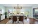 Virtually staged dining room with a modern table and chairs, hardwood floors and access to the patio at 1312 Leland Dr # 61, Sun City Center, FL 33573