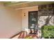 Front entry with stone and stucco exterior, featuring a glass door and terracotta tile flooring at 1312 Leland Dr # 61, Sun City Center, FL 33573
