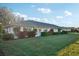 Rear view of house with landscaping and grassy area at 1312 Leland Dr # 61, Sun City Center, FL 33573