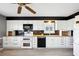 Modern kitchen with white cabinets and black tile backsplash at 1312 Leland Dr # 61, Sun City Center, FL 33573