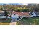 Aerial view of a two-story house with tile roof and lush landscaping at 14157 Feather Sound Dr, Clearwater, FL 33762