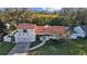 Stunning aerial view of a two-story house with a tile roof at 14157 Feather Sound Dr, Clearwater, FL 33762