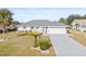 Single-story home with gray driveway and landscaping at 2024 N Pebble Beach Blvd, Sun City Center, FL 33573