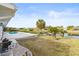 Landscaped backyard with pool and canal view at 2024 N Pebble Beach Blvd, Sun City Center, FL 33573