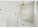 Walk-in shower with marble and penny tile floor and gold fixtures at 2024 N Pebble Beach Blvd, Sun City Center, FL 33573