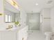 Spa-like bathroom with walk-in shower, double vanity, and gold accents at 2024 N Pebble Beach Blvd, Sun City Center, FL 33573