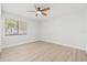 Bright bedroom featuring light walls and wood-look flooring at 2024 N Pebble Beach Blvd, Sun City Center, FL 33573