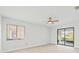 Bright bedroom with wood-look floors, ceiling fan, and sliding glass doors to patio at 2024 N Pebble Beach Blvd, Sun City Center, FL 33573