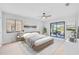Main bedroom with wood-look floors, ceiling fan, and access to patio at 2024 N Pebble Beach Blvd, Sun City Center, FL 33573