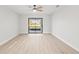 Bright bedroom with wood-look floors and sliding glass doors to patio at 2024 N Pebble Beach Blvd, Sun City Center, FL 33573