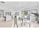 Bright dining room with modern chandelier and view to the kitchen and backyard at 2024 N Pebble Beach Blvd, Sun City Center, FL 33573