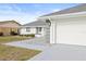 White garage door with gray trim and walkway at 2024 N Pebble Beach Blvd, Sun City Center, FL 33573