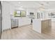 Modern kitchen with white cabinets, quartz countertops, and stainless steel appliances at 2024 N Pebble Beach Blvd, Sun City Center, FL 33573
