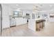 Modern kitchen with white cabinets, quartz countertops, and island with seating at 2024 N Pebble Beach Blvd, Sun City Center, FL 33573