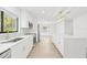 Modern kitchen with white cabinets, quartz countertops, and stainless steel appliances at 2024 N Pebble Beach Blvd, Sun City Center, FL 33573