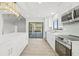 Contemporary kitchen with white cabinets, stainless steel appliances, and island at 2024 N Pebble Beach Blvd, Sun City Center, FL 33573