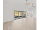 Living room with vaulted ceiling, hardwood floors, and sliding glass doors at 2024 N Pebble Beach Blvd, Sun City Center, FL 33573
