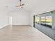 Spacious living room with hardwood floors, high ceilings, and access to the pool at 2024 N Pebble Beach Blvd, Sun City Center, FL 33573