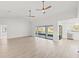 Open living room with hardwood floors, high ceilings, and sliding doors to lanai at 2024 N Pebble Beach Blvd, Sun City Center, FL 33573