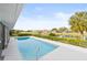 Relaxing rectangular pool with a view of a canal and neighborhood at 2024 N Pebble Beach Blvd, Sun City Center, FL 33573