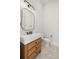 Modern bathroom with a wooden vanity, white sink, and herringbone floor at 2218 S Occident St, Tampa, FL 33629