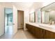 Modern bathroom with double vanity, large mirrors, and tile flooring at 2246 Fiesta Dr, Sarasota, FL 34231