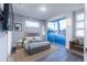 Modern bedroom with a gray bed and sliding glass doors to balcony at 2246 Fiesta Dr, Sarasota, FL 34231