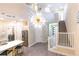 Bright and spacious entryway with a large chandelier and staircase at 2246 Fiesta Dr, Sarasota, FL 34231