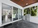 Covered patio with built-in stainless steel grill and access to living area at 2246 Fiesta Dr, Sarasota, FL 34231