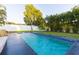 Relaxing rectangular pool with dark gray coping and blue tile at 2246 Fiesta Dr, Sarasota, FL 34231