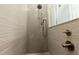 Walk-in shower with gray tile and pebble floor at 2246 Fiesta Dr, Sarasota, FL 34231