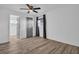 Spacious bedroom with wood-look flooring and ceiling fan at 2514 Ohio S Ct, Gulfport, FL 33707