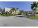 Front entrance to the community clubhouse with palm trees at 2614 Cove Cay Dr # 409, Clearwater, FL 33760