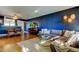 Open living and dining area with stylish furniture and dark blue walls at 2614 Cove Cay Dr # 409, Clearwater, FL 33760