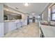 Modern kitchen featuring white cabinets, stainless steel appliances, and a large island at 2618 Locksley St, Sun City Center, FL 33573