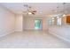 Living area with tile floors, kitchen access, and view of patio at 2821 Holly Bluff Ct, Plant City, FL 33566