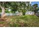 Spacious backyard with a pergola, shed, and large tree providing shade at 2883 16Th Ave N, St Petersburg, FL 33713