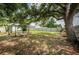 Relaxing backyard patio under a large shade tree with seating area at 2883 16Th Ave N, St Petersburg, FL 33713