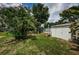 Backyard with shed, palm tree, and seating area near the fence at 2883 16Th Ave N, St Petersburg, FL 33713