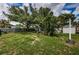 Large backyard with a grassy area and mature trees at 2883 16Th Ave N, St Petersburg, FL 33713