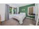 Bright bedroom with a double bed and green accent wall at 2883 16Th Ave N, St Petersburg, FL 33713