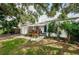 House exterior showcasing a large front yard with mature trees and a walkway to the entrance at 2883 16Th Ave N, St Petersburg, FL 33713