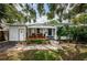 White bungalow with a covered porch and lush landscaping, offering curb appeal at 2883 16Th Ave N, St Petersburg, FL 33713