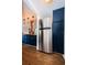 Stainless steel refrigerator in a stylish kitchen with blue cabinetry at 2883 16Th Ave N, St Petersburg, FL 33713